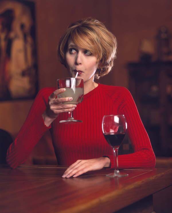 Amy Reiley taking a sip through a straw from a drink 