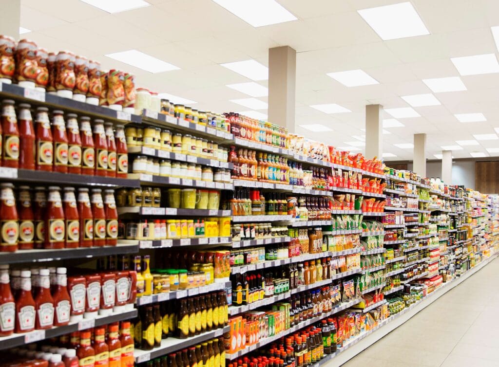 Packed supermarket shelf with tins and cans