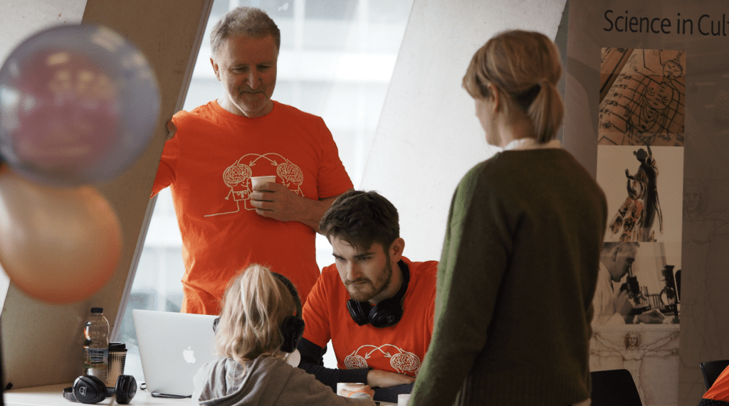 Professor Barry Smith with a collegue and a mum and daughter at the Tate Modern doing a taste experiment with headphones