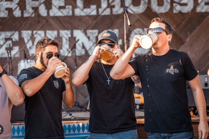 Three men are drinking beer