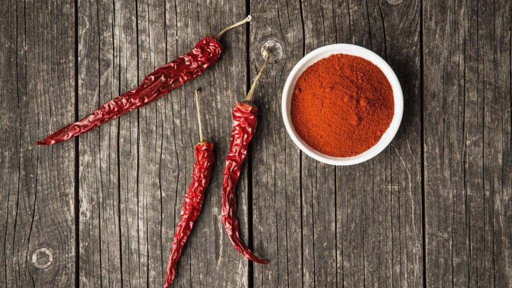 Picture of dried chili and chili powder with wooden background. Credit to Canva. Picture of dried chili and chili powder with wooden background. Credit to Canva.