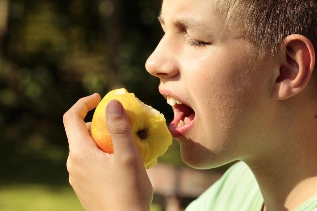 Person biting into an apple