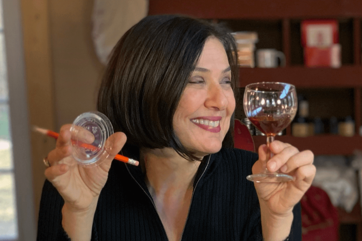 MARCHESE Marchese holding a glass with honey in it