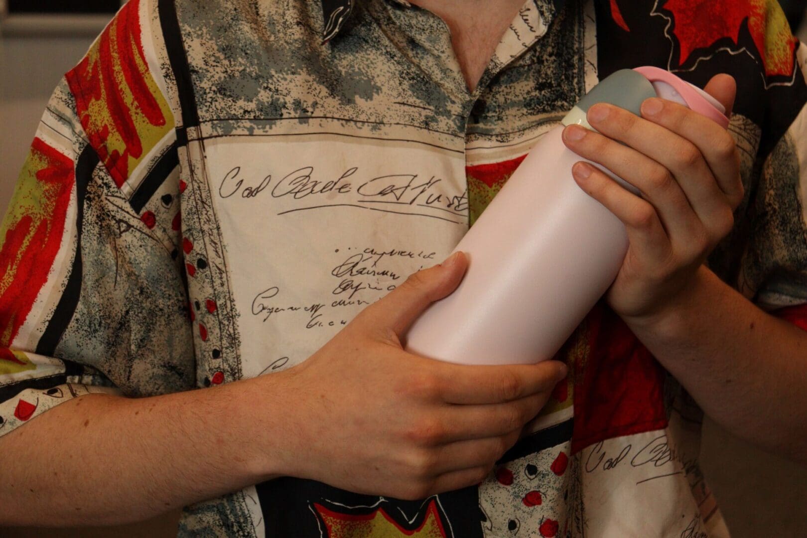 Water bottle being held to a person's chest